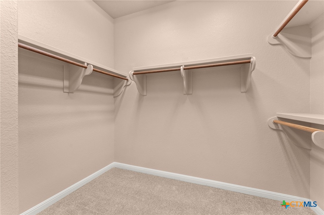 10300 Morado Cove, Unit 503 Austin, TX 78759 - Photo 18 of 33 The walk-in closet in the primary bedroom offers excellent storage space.