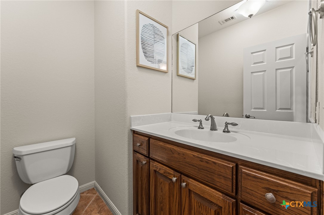10300 Morado Cove, Unit 503 Austin, TX 78759 - Photo 22 of 33 The half bathroom is conveniently located on the first floor.