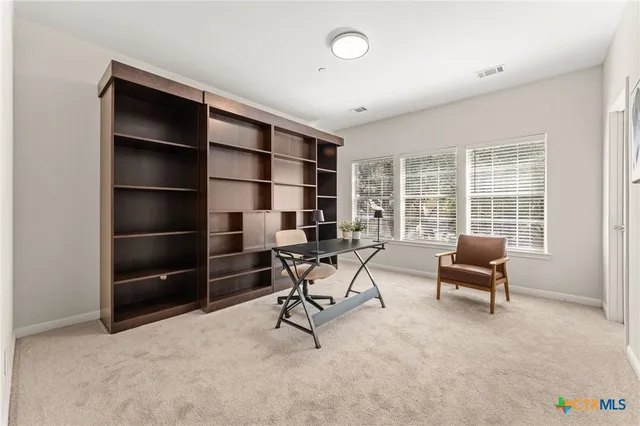 a living room with furniture and a floor to ceiling window
