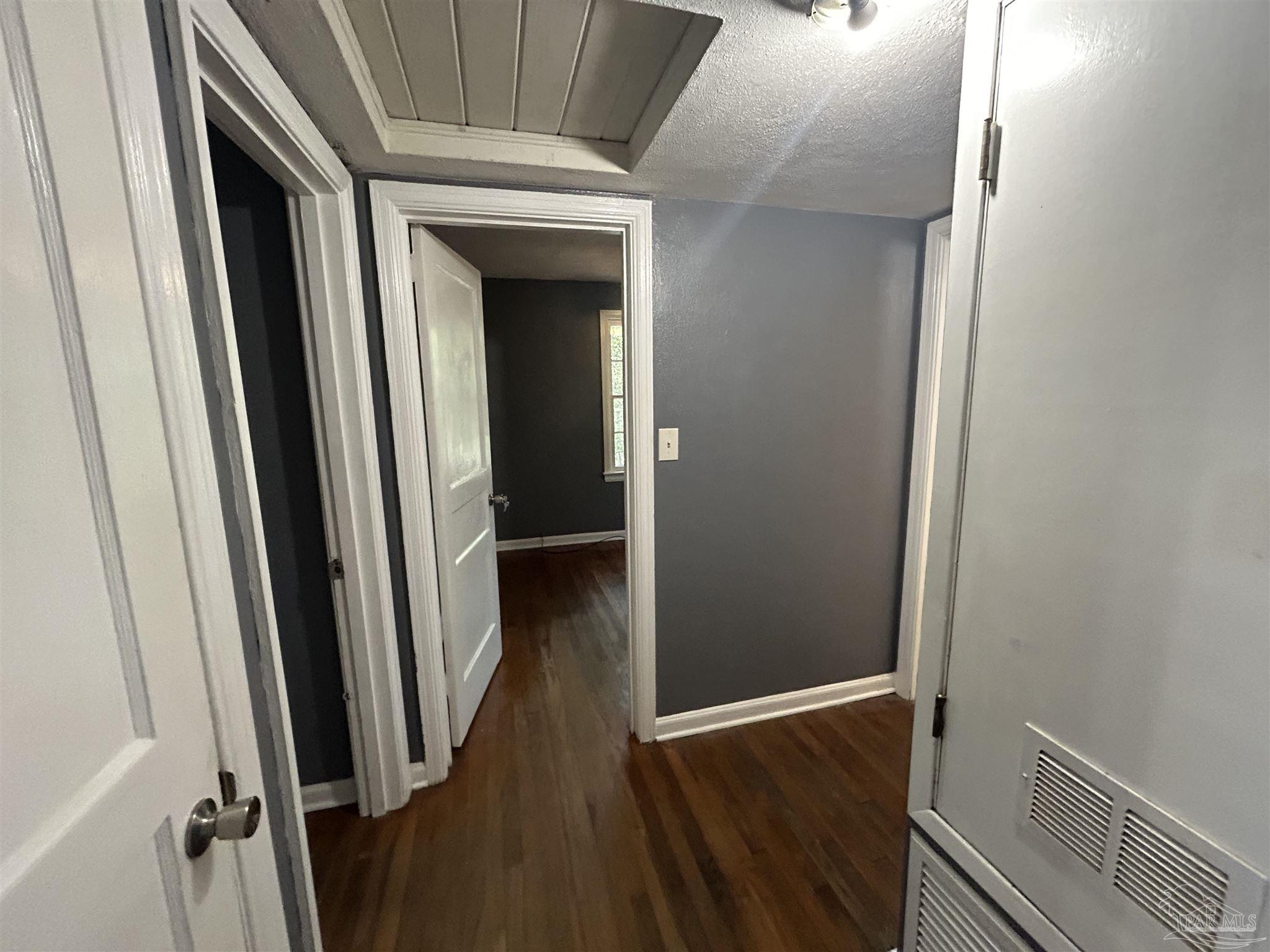 210 Milton Road Pensacola, FL 32507 - Photo 9 of 17 a view of hallway with stairs and wooden floor
