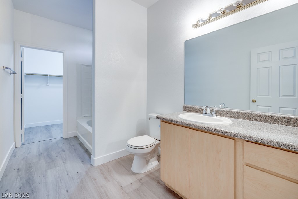 4915 East Russell Road, Unit 127 Las Vegas, NV 89120 - Photo 13 of 19 A well-appointed bath with a vanity, toilet, and light-toned flooring.