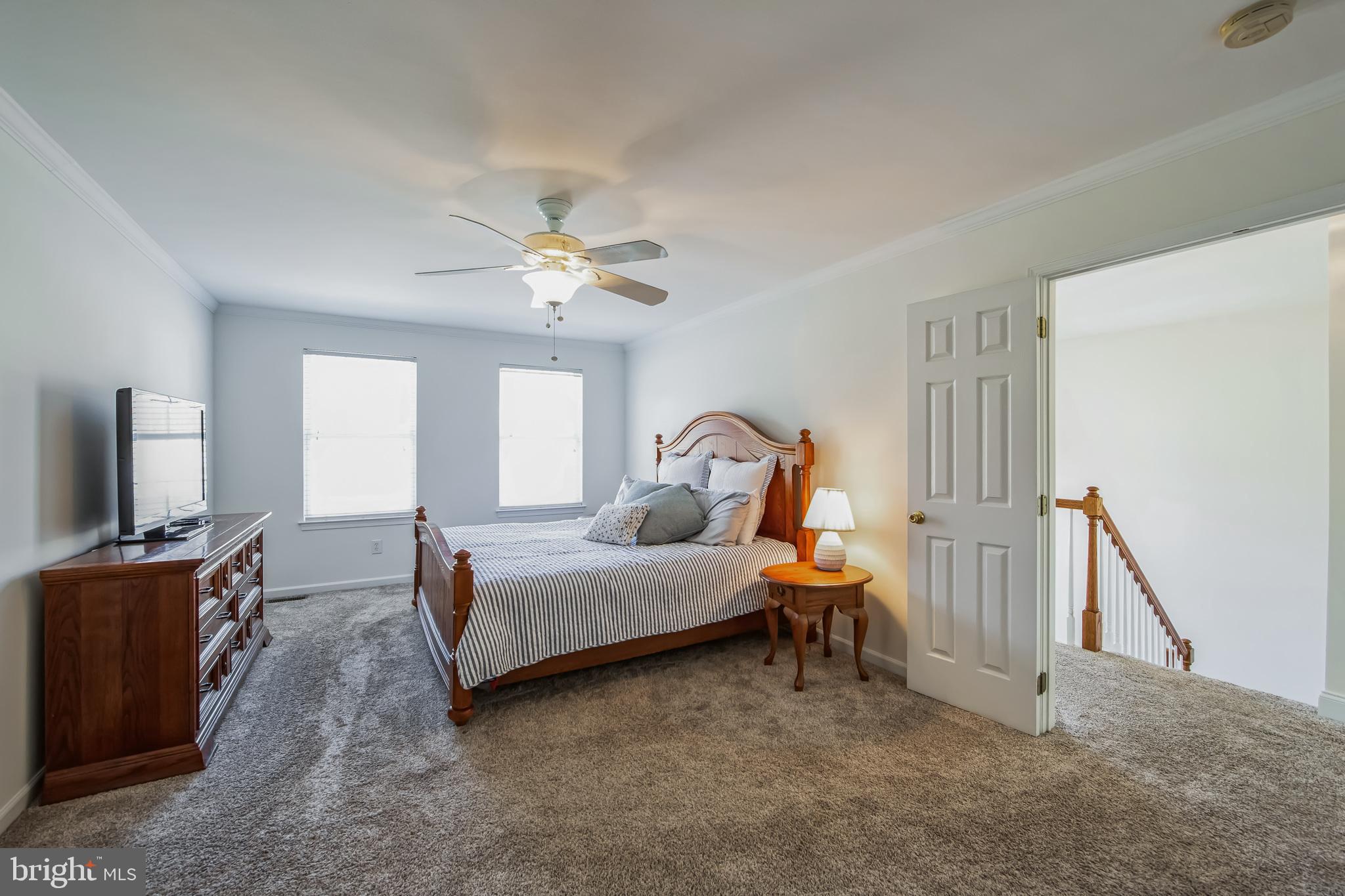684 Highspire Road Glenmoore, PA 19343 - Photo 19 of 46 a bedroom with a bed and a chandelier