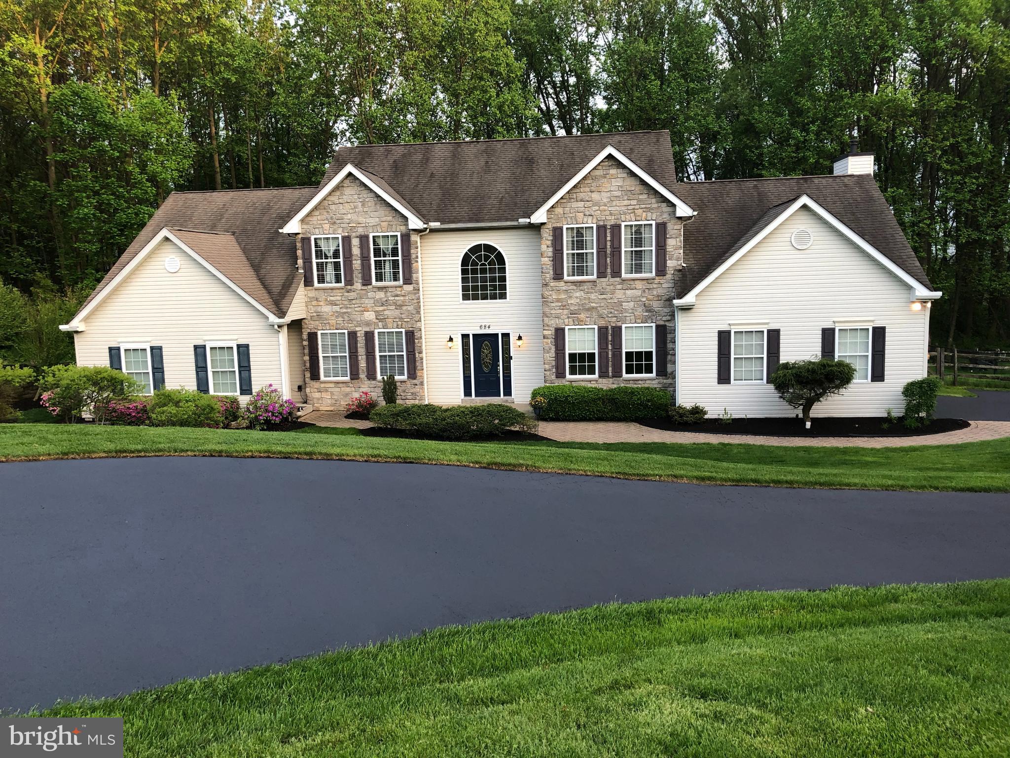 684 Highspire Road Glenmoore, PA 19343 - Photo 2 of 46 a front view of a house with a garden and plants