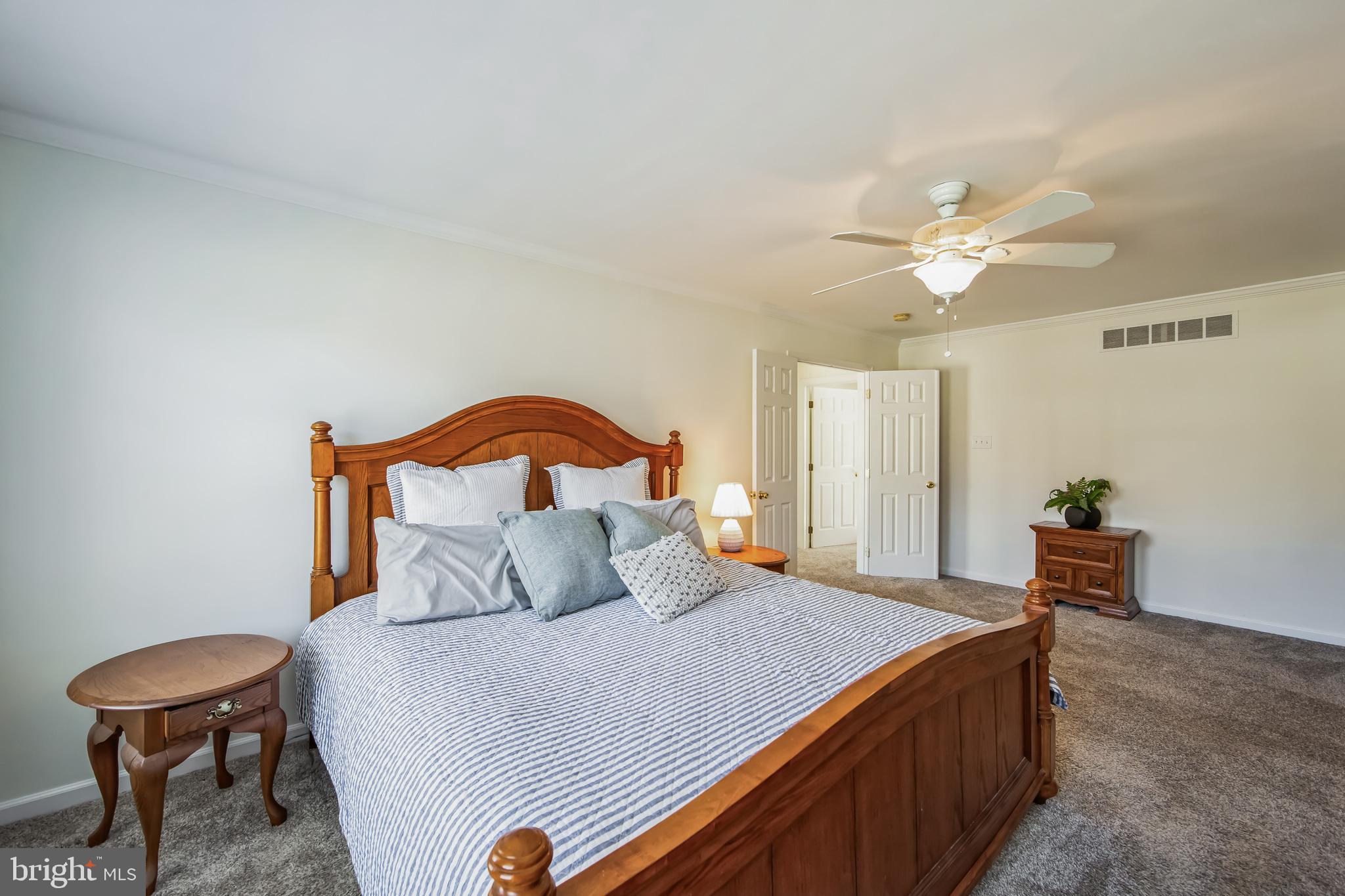 684 Highspire Road Glenmoore, PA 19343 - Photo 21 of 46 a bedroom with a bed and a chandelier