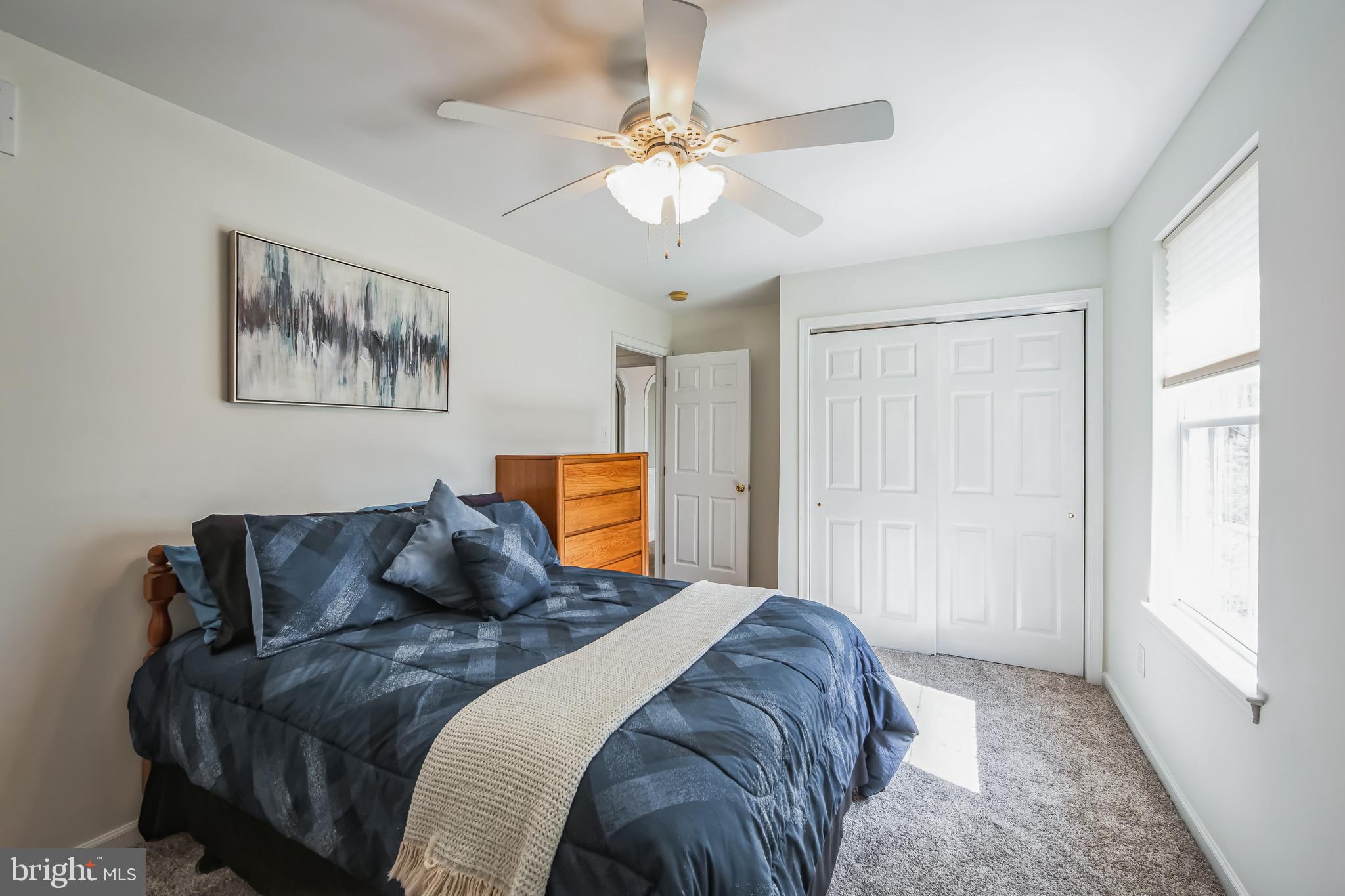 684 Highspire Road Glenmoore, PA 19343 - Photo 25 of 46 a bedroom with a bed and a chandelier