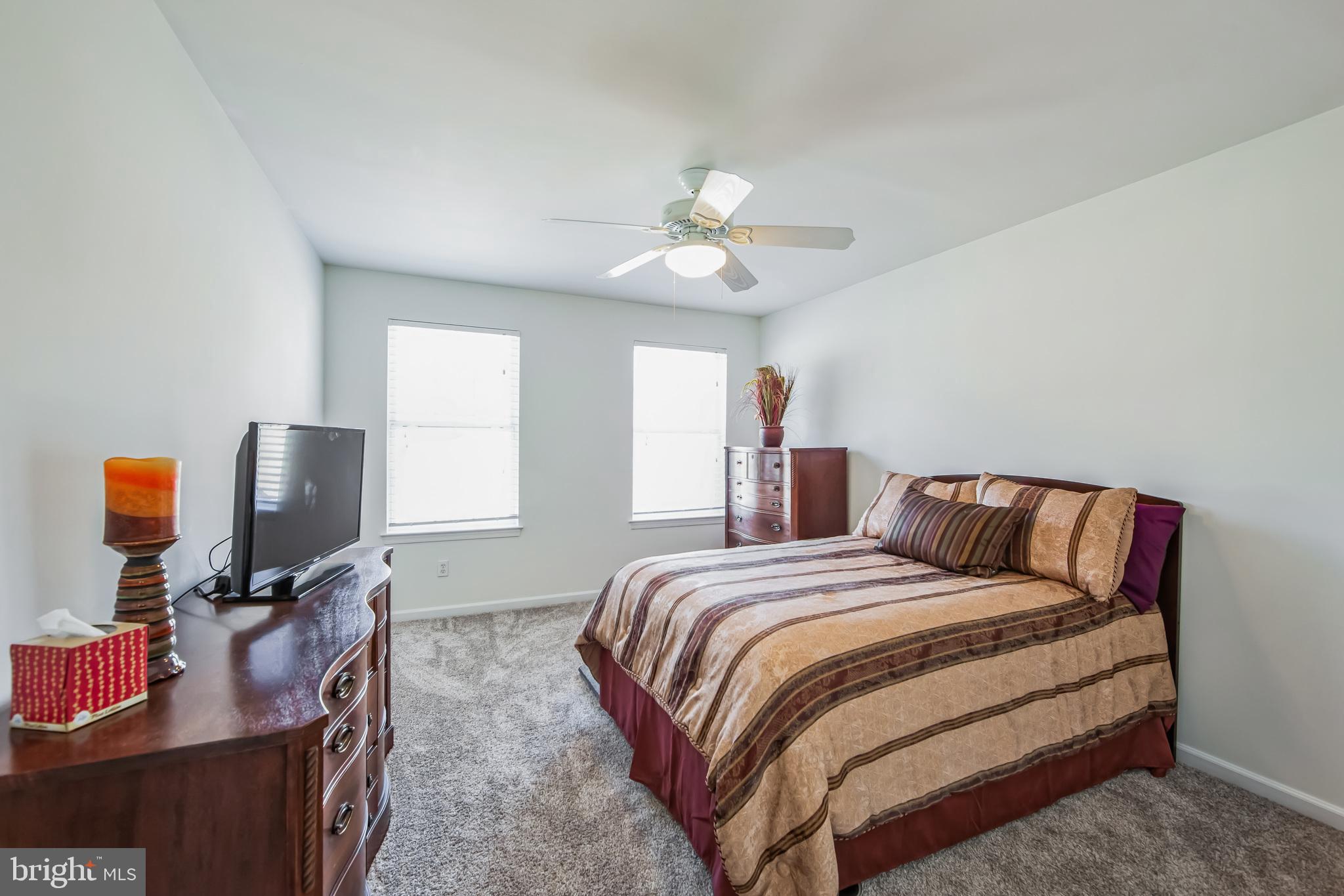 684 Highspire Road Glenmoore, PA 19343 - Photo 26 of 46 a bedroom with a bed and a chandelier