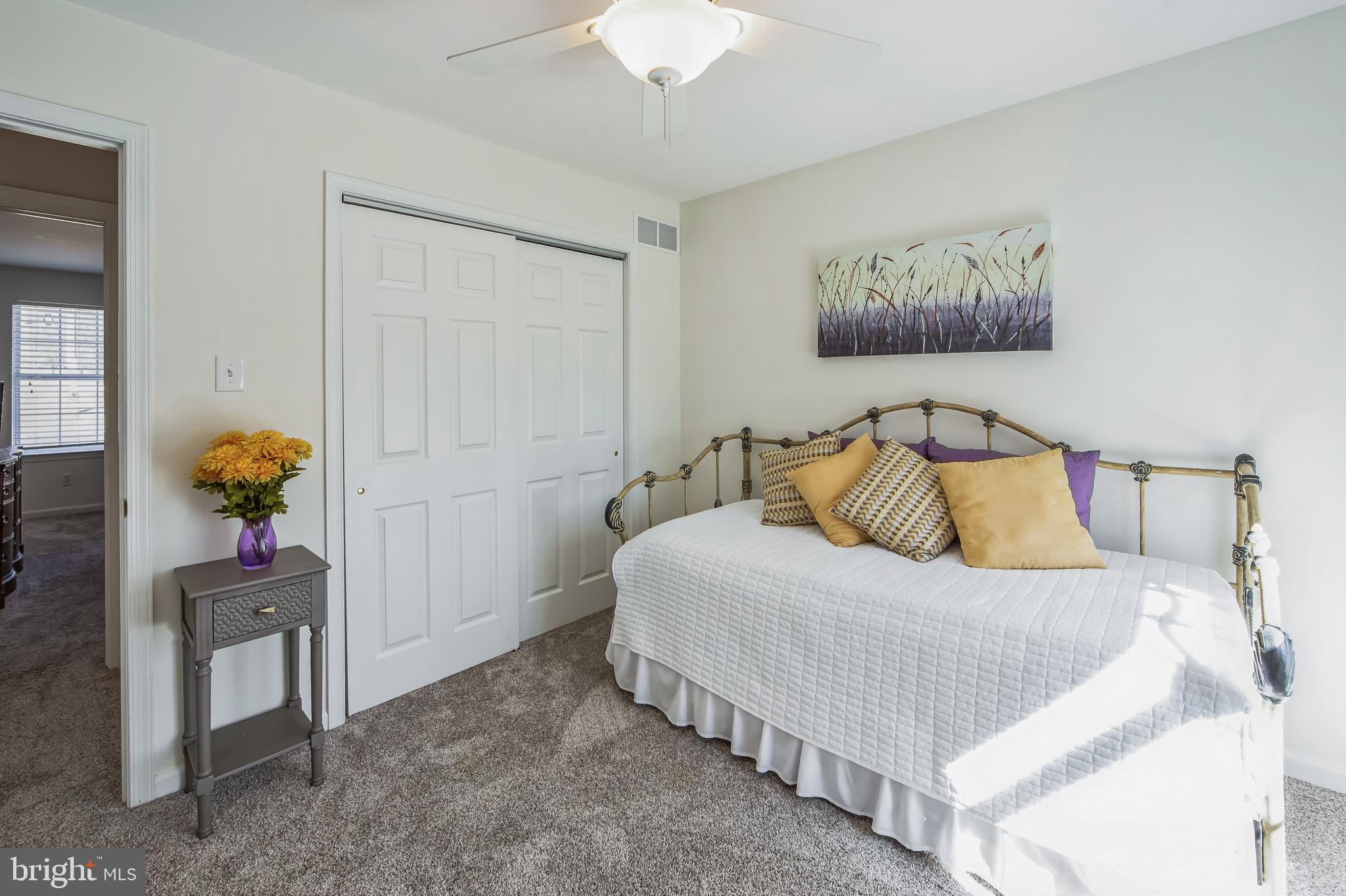 684 Highspire Road Glenmoore, PA 19343 - Photo 29 of 46 a bedroom with a bed and a chandelier