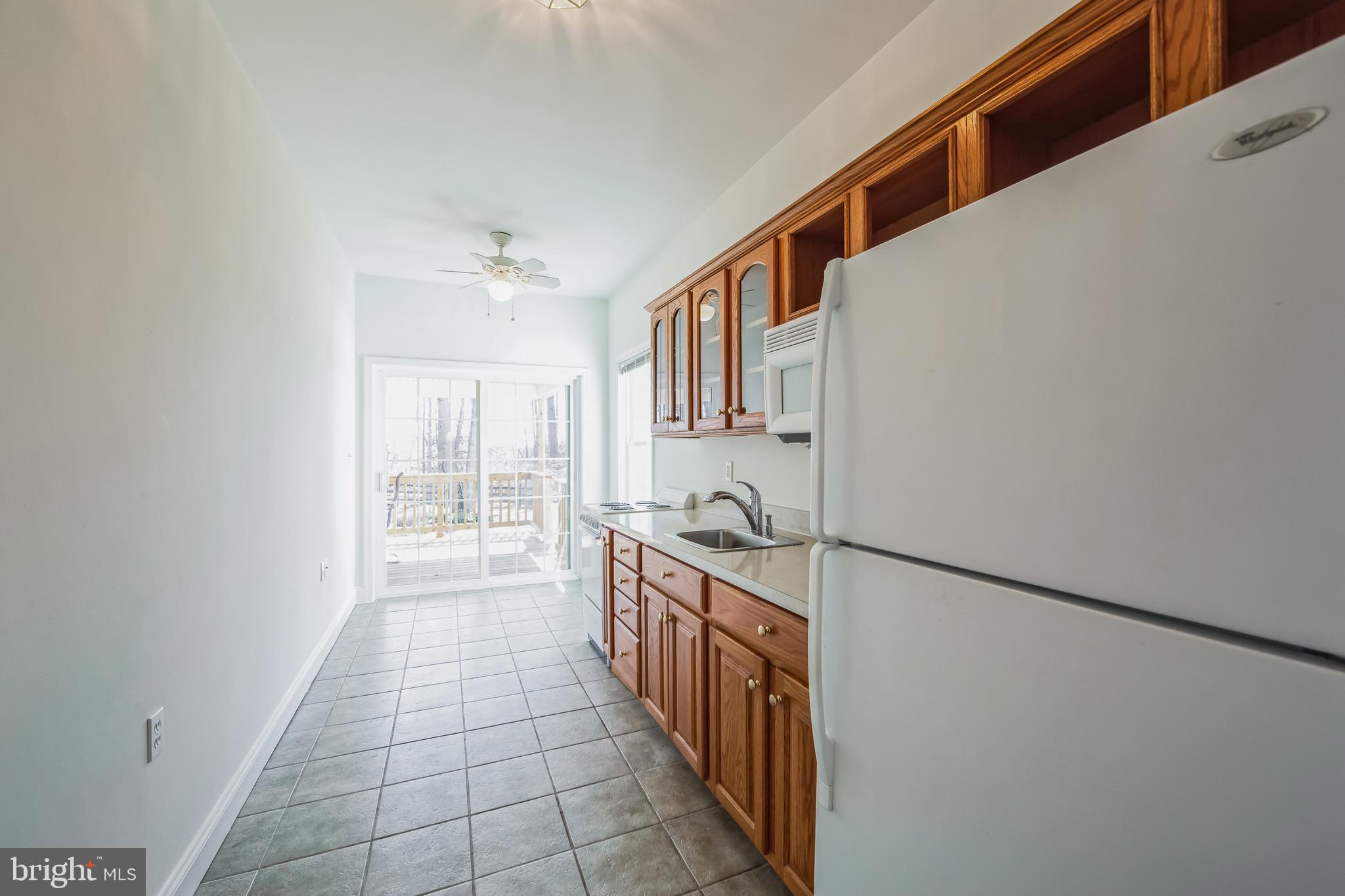 684 Highspire Road Glenmoore, PA 19343 - Photo 33 of 46 a hallway with a stove top oven a sink and dishwasher