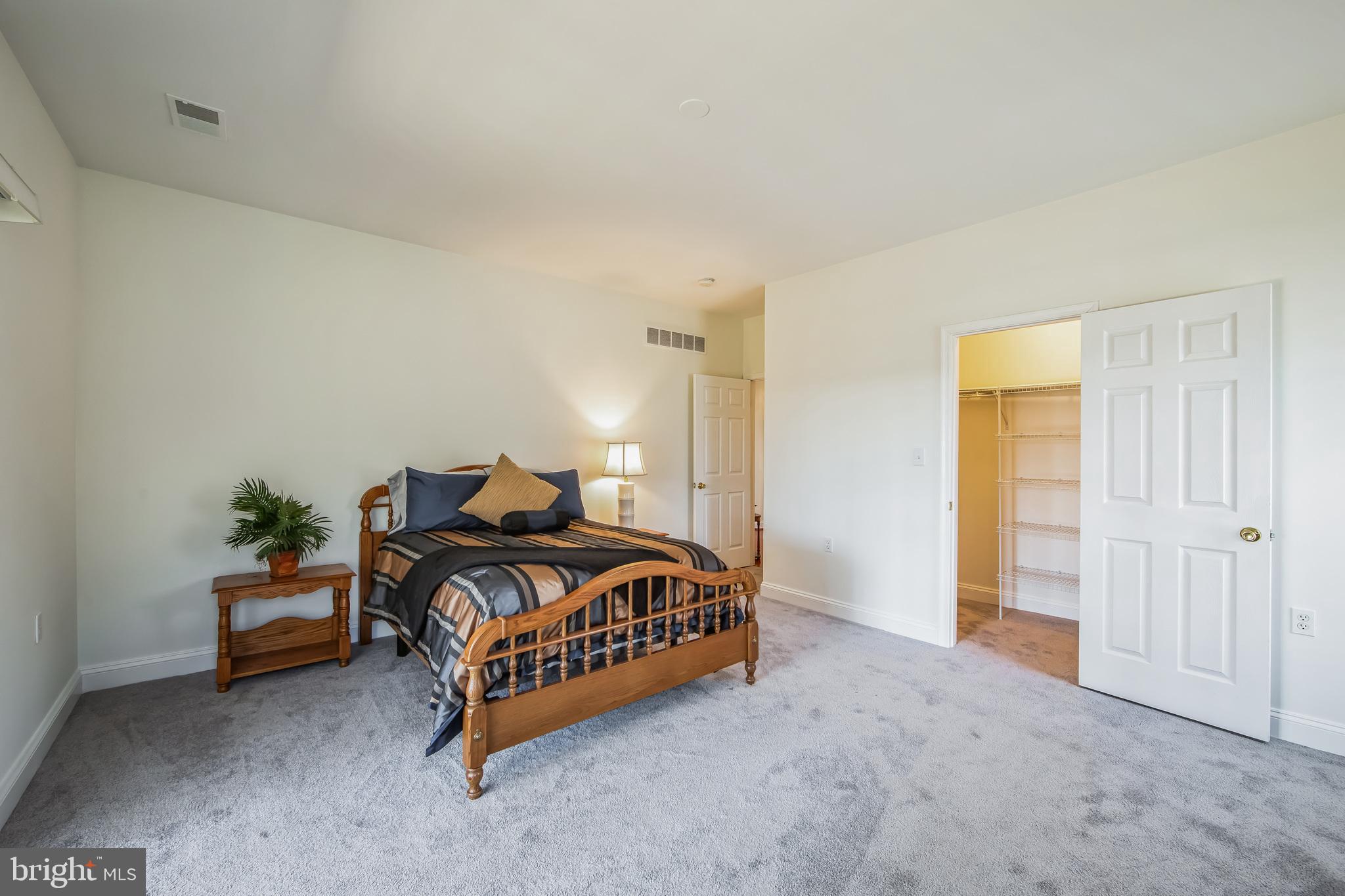 684 Highspire Road Glenmoore, PA 19343 - Photo 34 of 46 a spacious bedroom with a bed and a cabinets