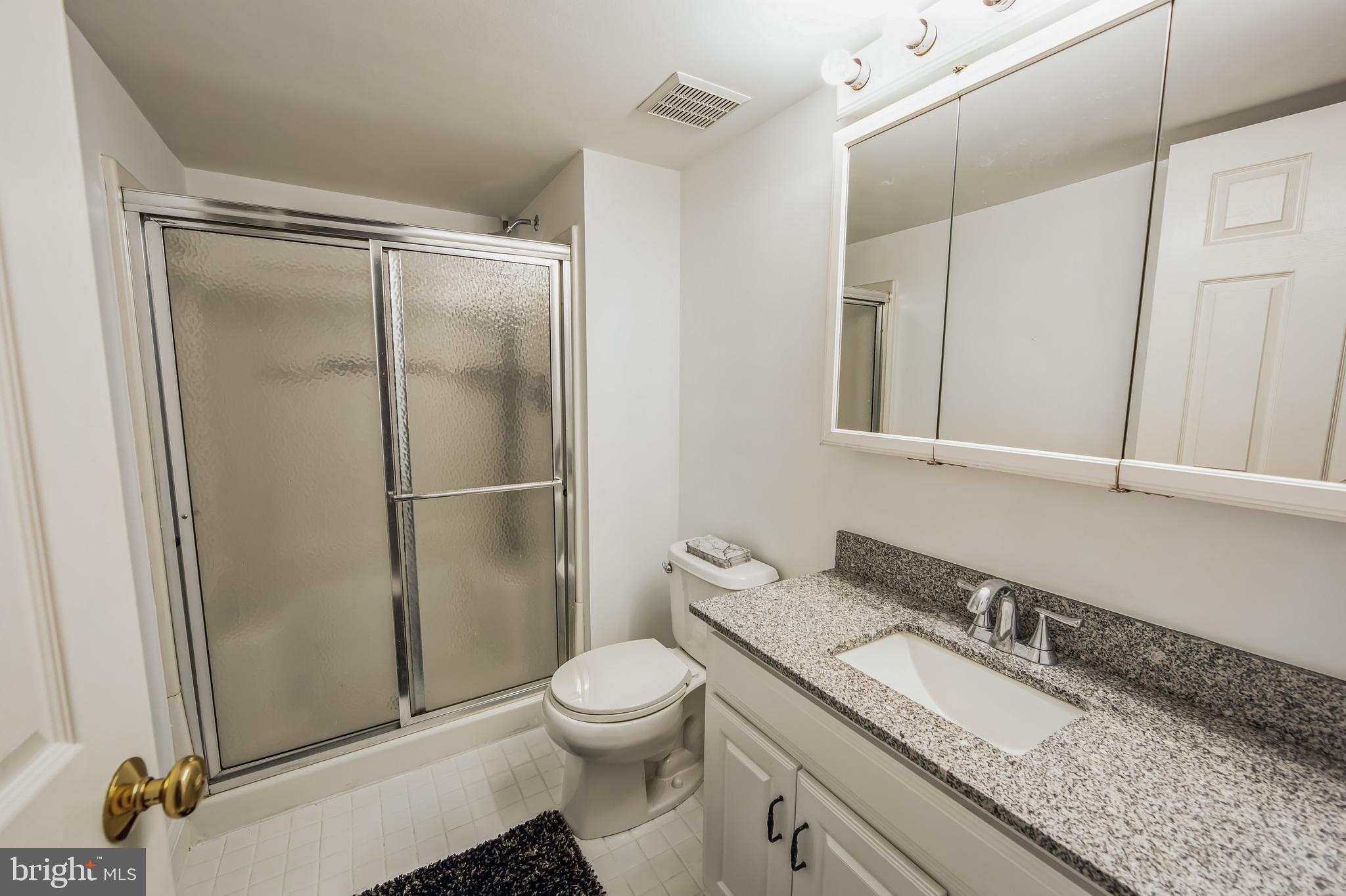 684 Highspire Road Glenmoore, PA 19343 - Photo 41 of 46 a bathroom with a granite countertop sink toilet and shower