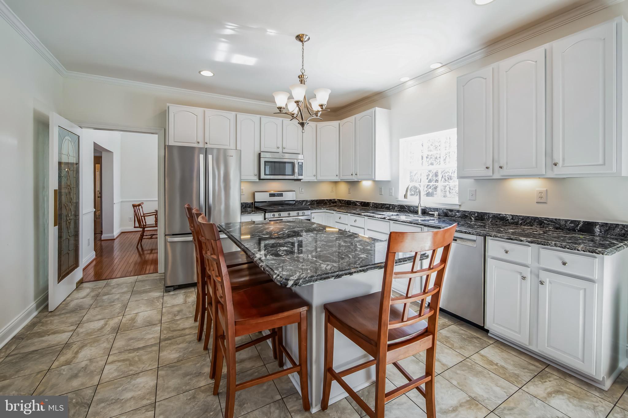 684 Highspire Road Glenmoore, PA 19343 - Photo 10 of 46 a kitchen with stainless steel appliances granite countertop a white table and chairs
