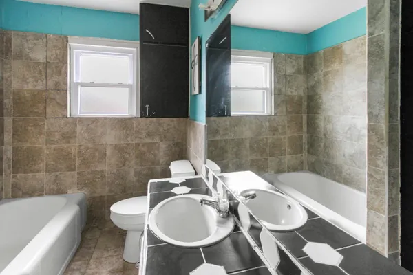 a bathroom with a sink a toilet and bathtub