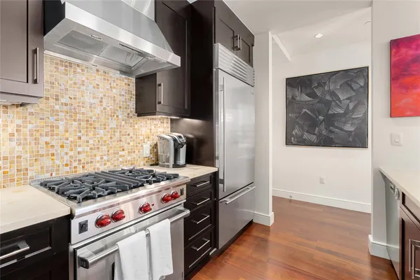 a kitchen with stainless steel appliances granite countertop a stove and a refrigerator