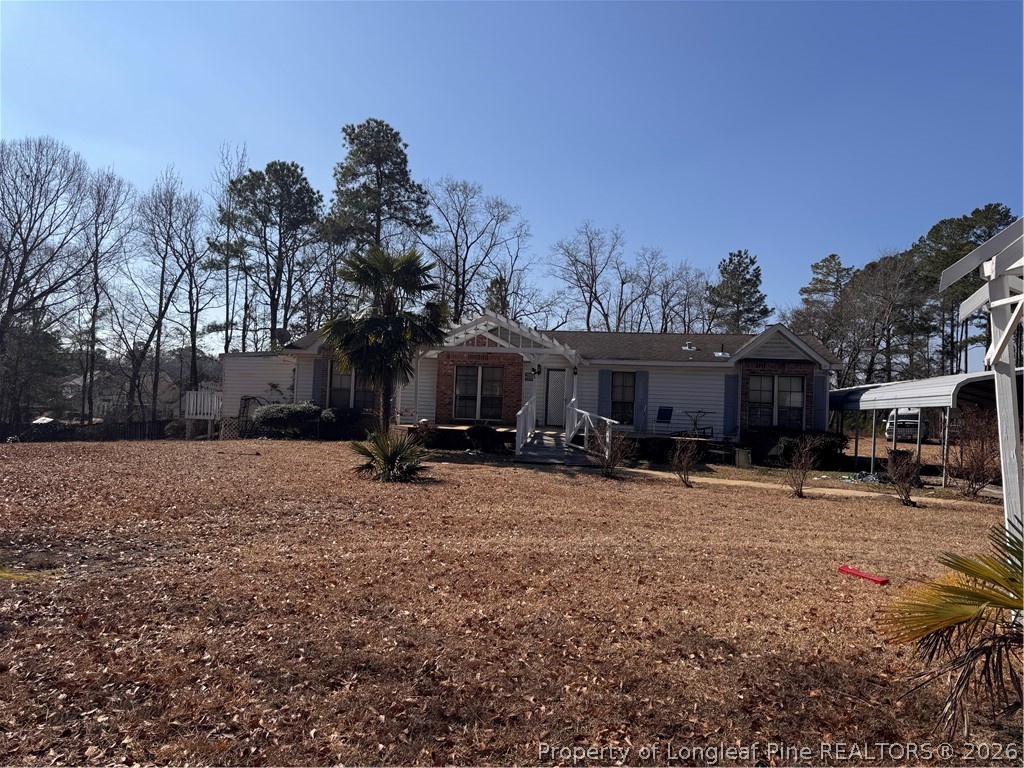 1188 Cypress Lakes Road Hope Mills, NC 28348 - Photo 1 of 9 a view of a house with a yard