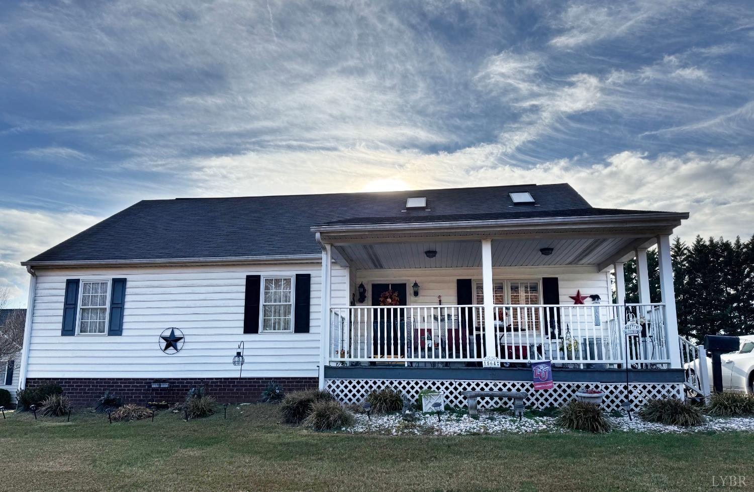 a view of a house with a yard and deck