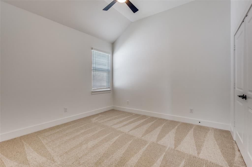 3308 Lakestriker Road Pilot Point, TX 76258 - Photo 16 of 25 an empty room with chandelier fan and windows