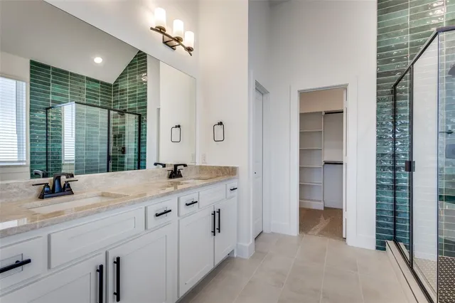 a bathroom with a double vanity sink and a mirror