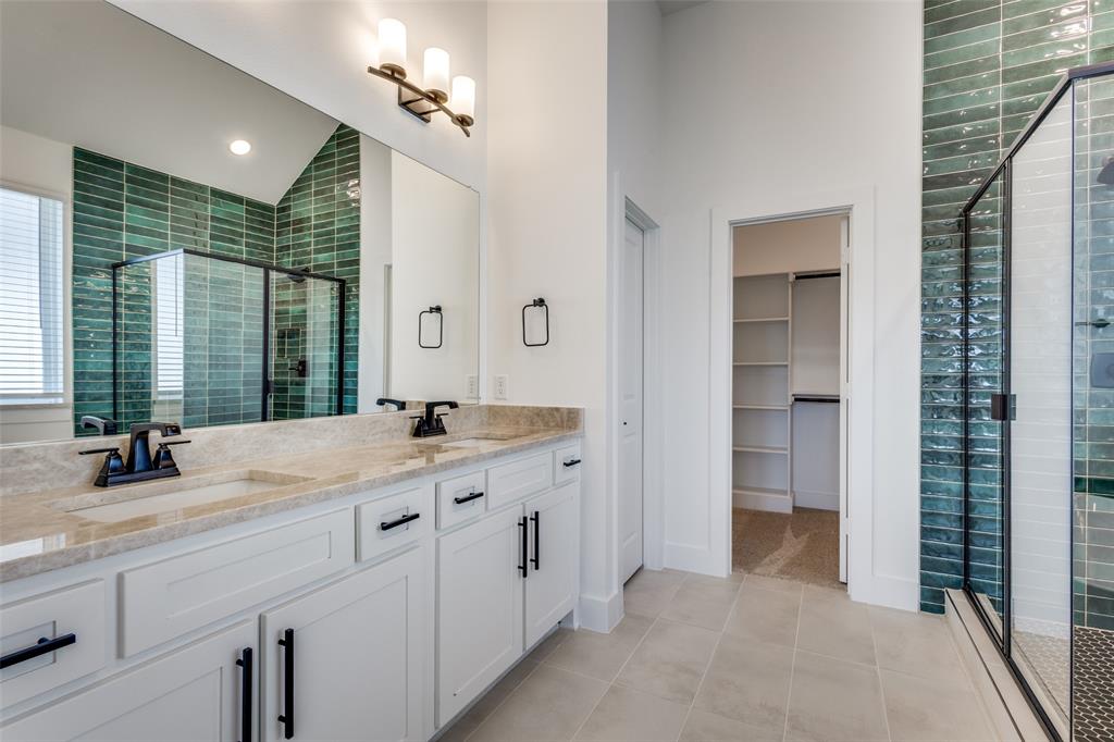 3308 Lakestriker Road Pilot Point, TX 76258 - Photo 22 of 25 a bathroom with a double vanity sink and a mirror