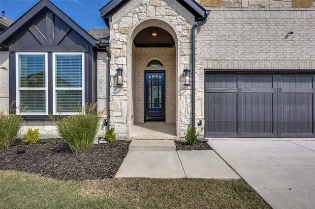 a view of a house with brick walls and windows