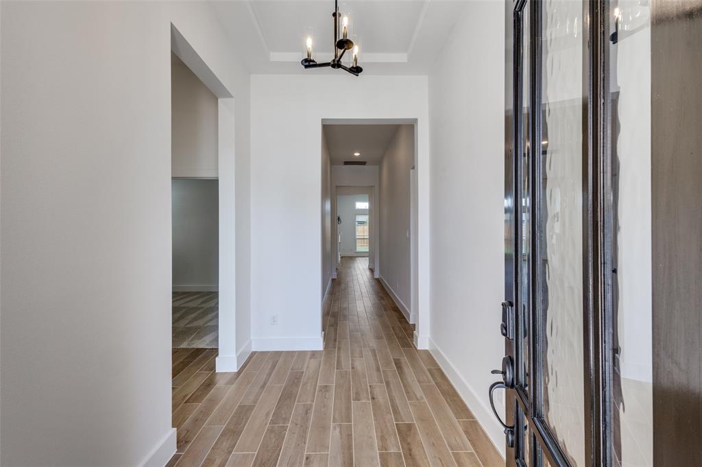 3308 Lakestriker Road Pilot Point, TX 76258 - Photo 5 of 25 a view of a hallway with wooden floor and a bathroom