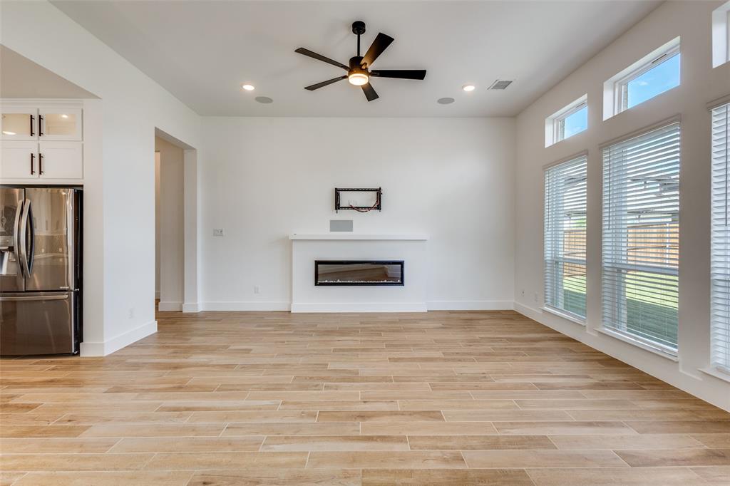 3308 Lakestriker Road Pilot Point, TX 76258 - Photo 6 of 25 a view of a livingroom with a ceiling fan a fireplace and a large window