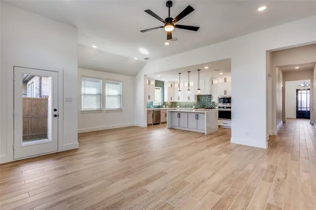 a view of a kitchen with wooden floor and a kitchen
