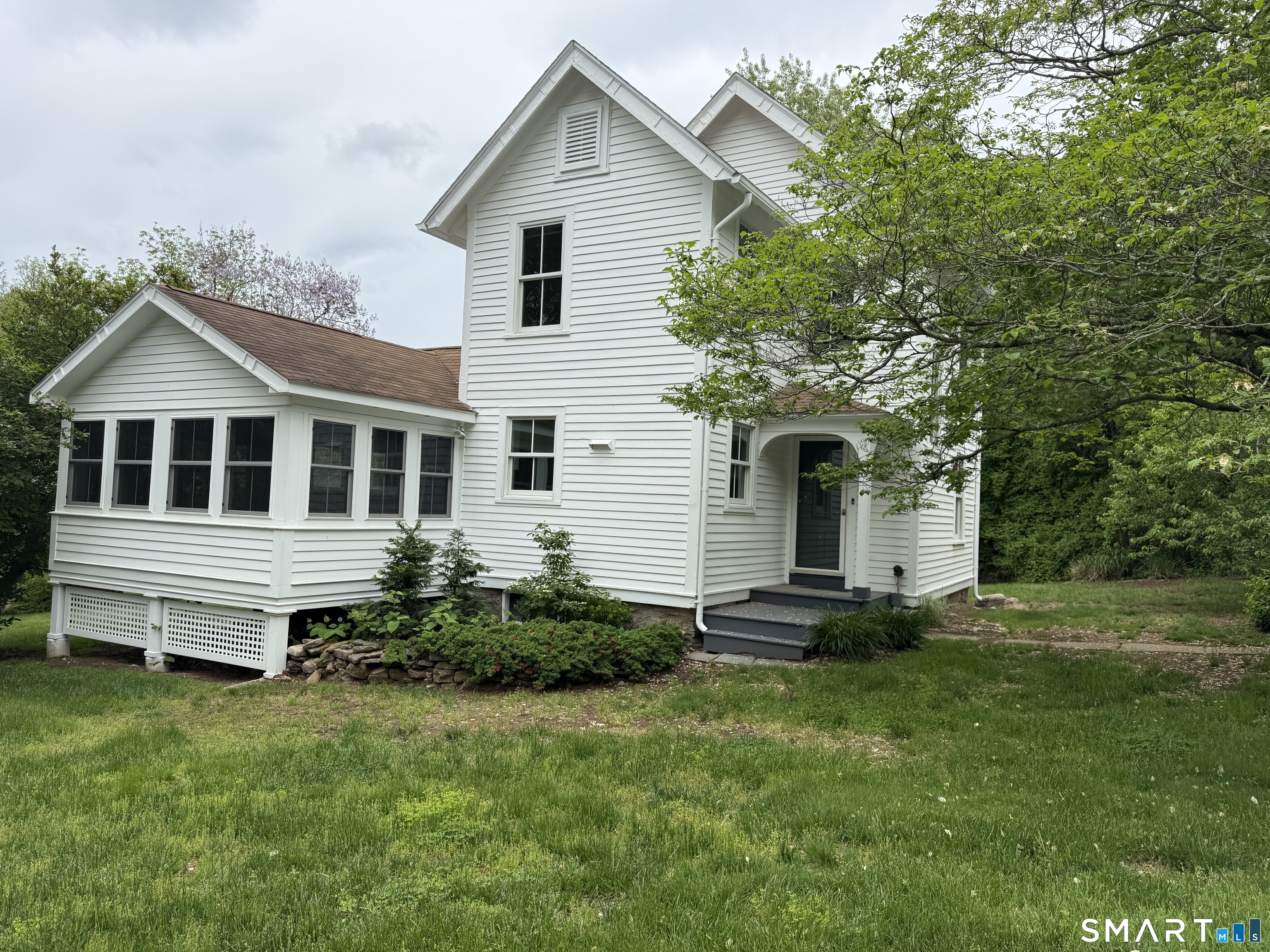 312 Ferry Road Old Lyme, CT 06371 - Photo 1 of 16 a front view of a house with a yard