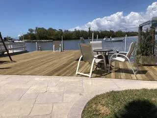 a view of a balcony with wooden floor and lake view