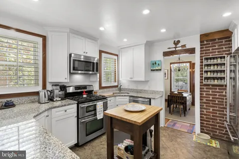 a kitchen that has a cabinets a sink and a stove in it