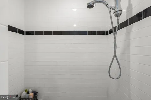 a bathroom with a sink mirror and shower
