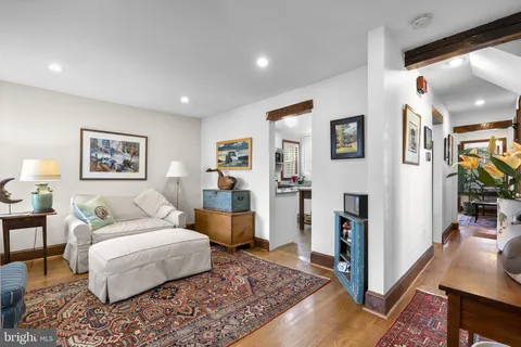 a spacious bedroom with a bed a couch and large window