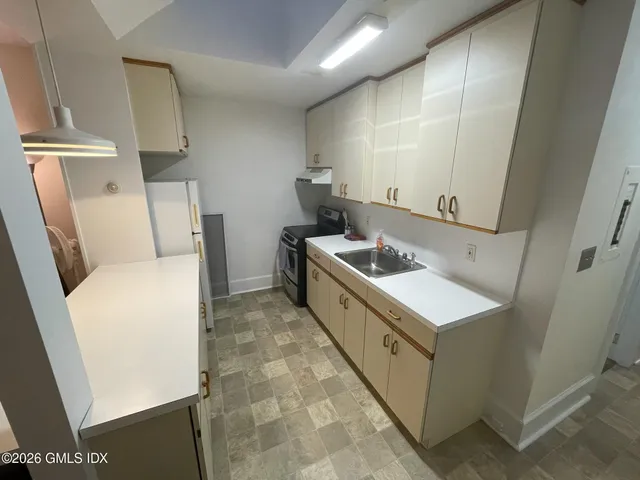 a utility room with cabinets washer and dryer