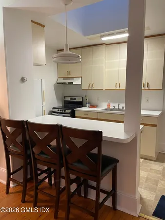 a kitchen with a wooden table and chairs