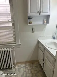 a bathroom with a sink toilet and cabinets