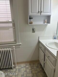 90 Riverside Avenue, Unit 1 Riverside, CT 06878 - Photo 8 of 10 a bathroom with a sink toilet and cabinets