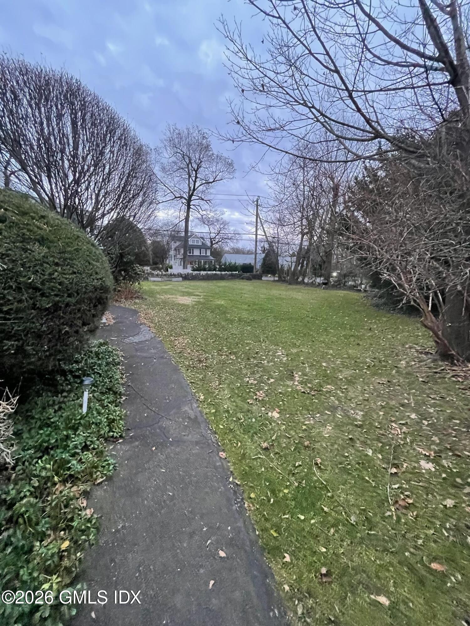90 Riverside Avenue, Unit 1 Riverside, CT 06878 - Photo 10 of 10 a view of a backyard with plants and large trees