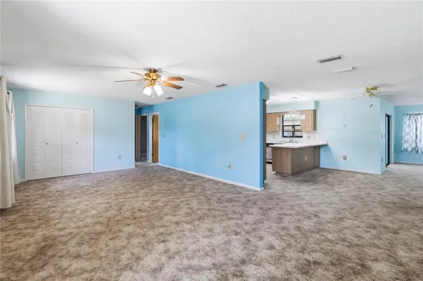 a view of a big room with closet and a chandelier fan