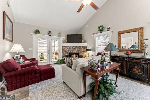 a living room with furniture fireplace and a window
