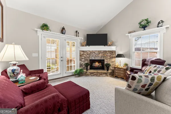 a living room with furniture large window and a fireplace