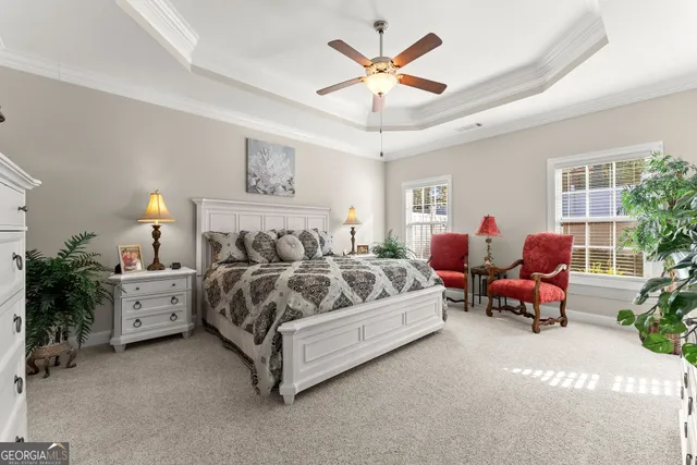 a spacious bedroom with a bed and a chandelier