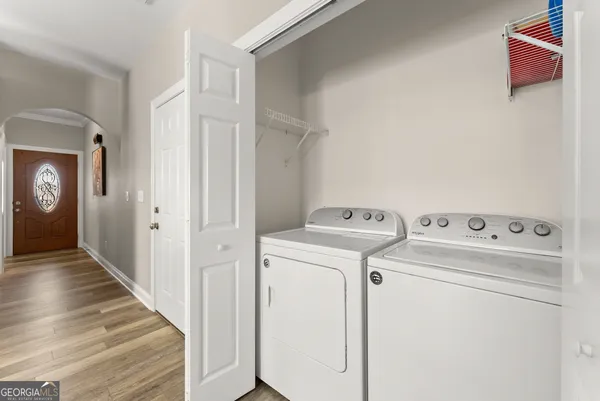 a view of washer and dryer with wooden in the kitchen