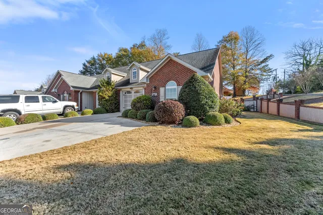 a view of a house with a yard covered in snow