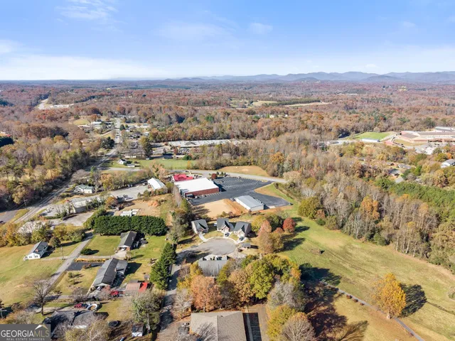 an aerial view of residential houses with city view