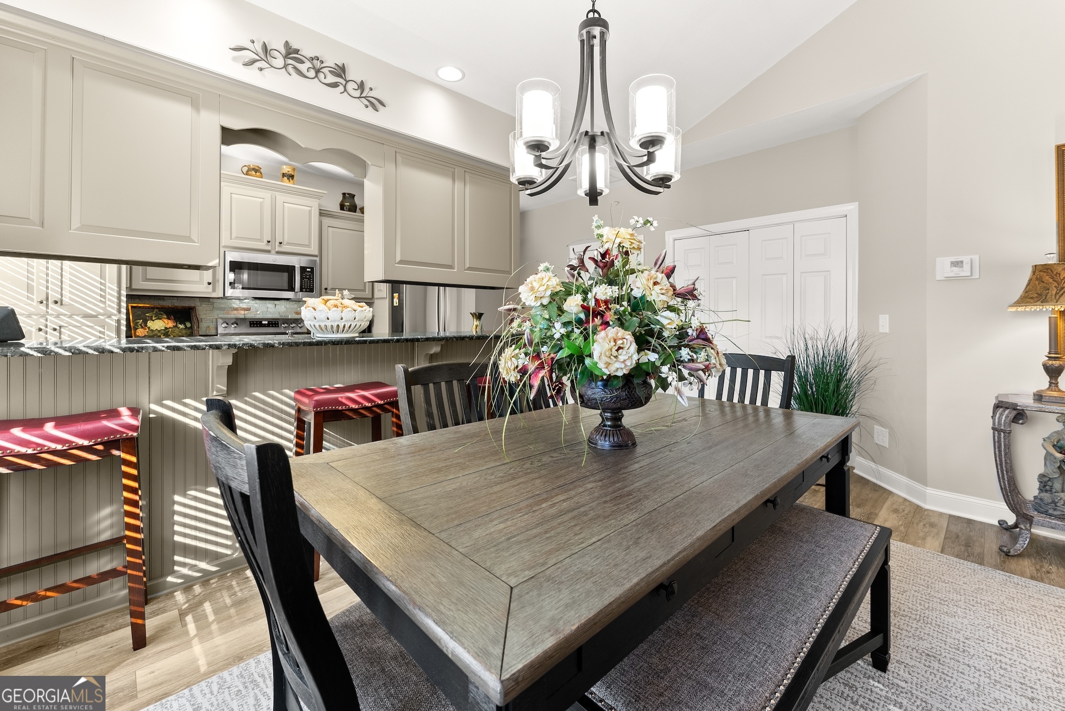 92 Colonial Drive, Unit 1 Cleveland, GA 30528 - Photo 10 of 43 a dining room with furniture a chandelier and wooden floor