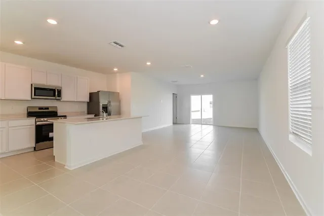 a view of kitchen with microwave and cabinets