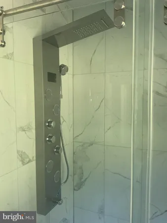 a bathroom with a sink and a white tub