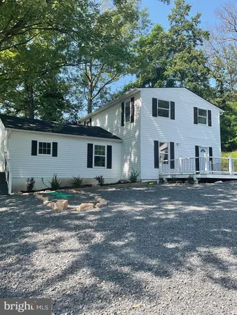 a view of a yard with a house and a tree