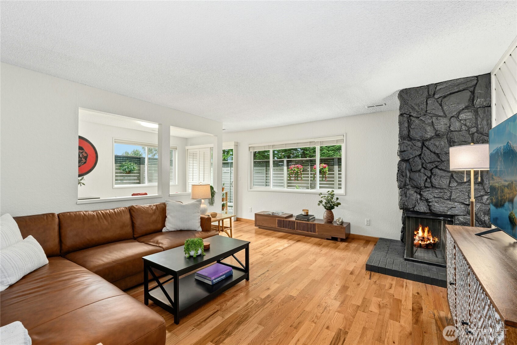 9523 Northeast 180th Street, Unit A102 Bothell, WA 98011 - Photo 1 of 29 a living room with furniture and a large window