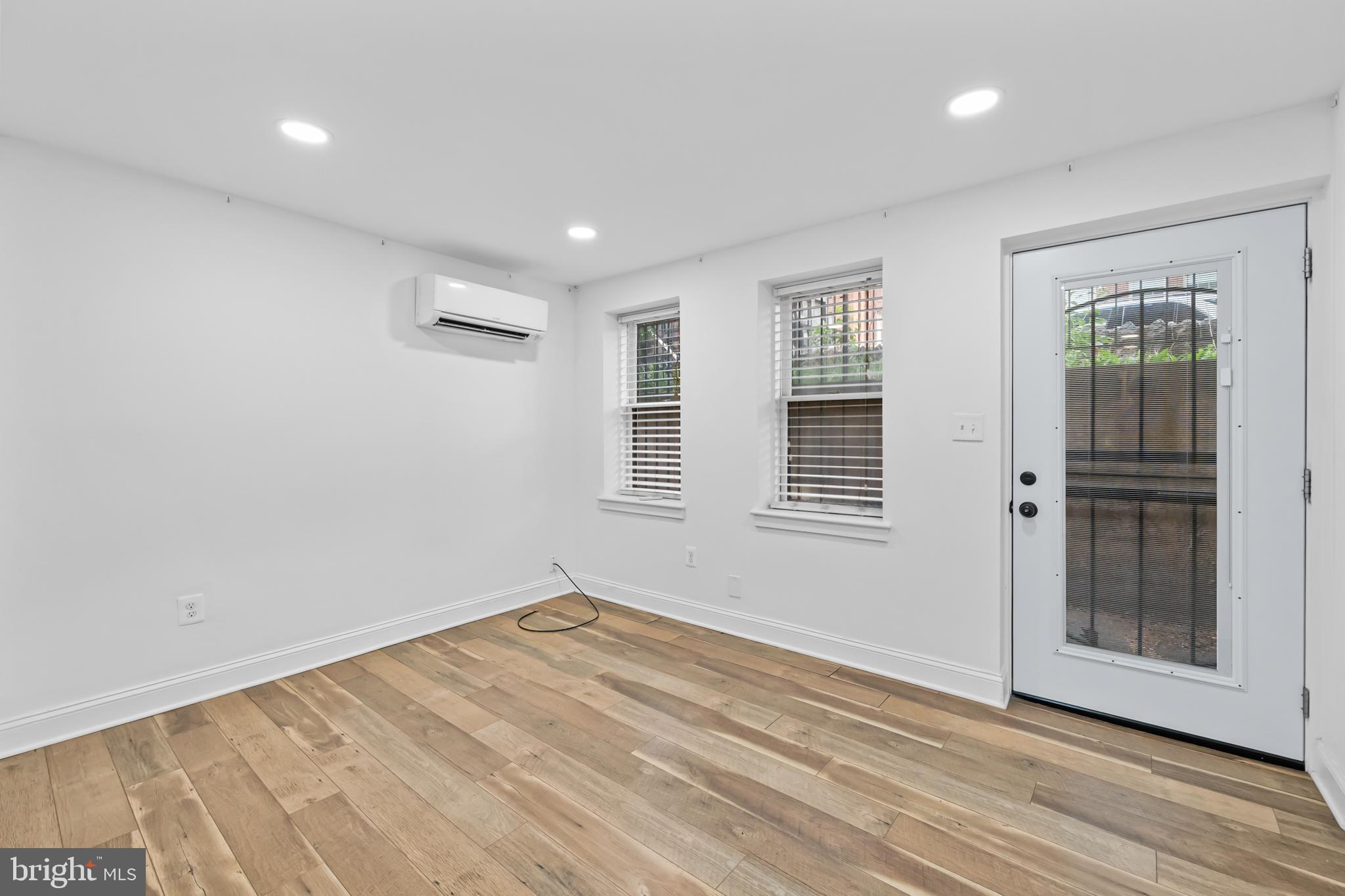 2032 15th Street Northwest, Unit 2 Washington, DC 20009 - Photo 4 of 28 an empty room with wooden floor and windows