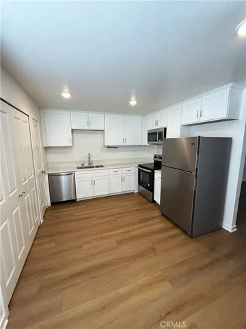 a kitchen with stainless steel appliances granite countertop a refrigerator sink and cabinets